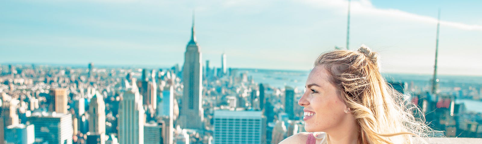 Pretty blond girl overlooking Empire State Building