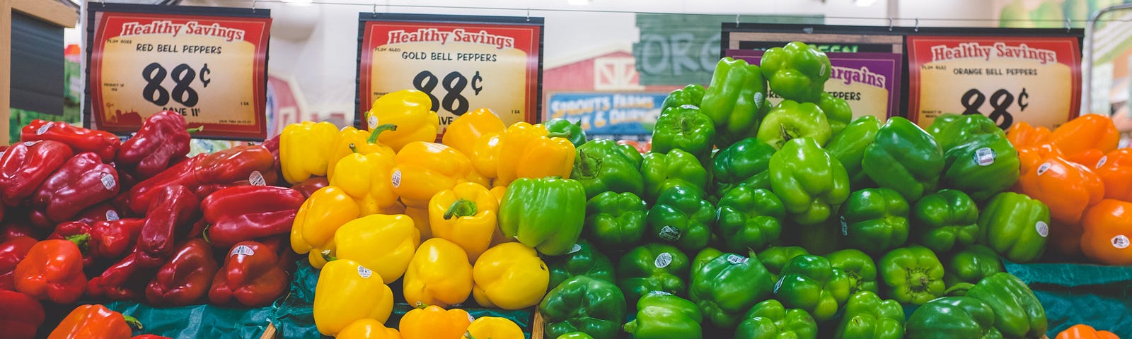 red, yellow and green peppers in a grocery store