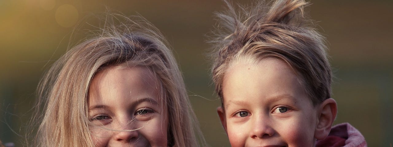 Two cheeky friends smiling.