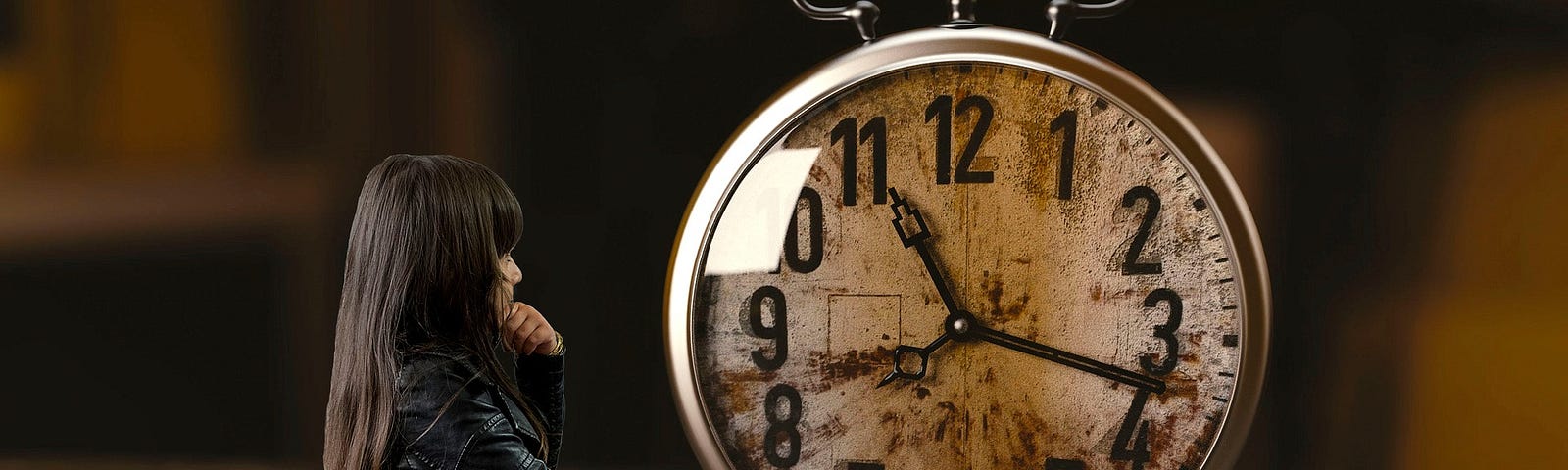 A young woman with black hair wearing a black raincoat stands and ponders an old-style rusted alarm clock that’s taller than her.