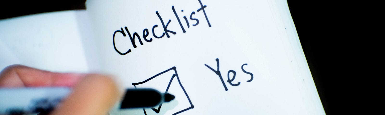 A picture of a notepad with text: checklist yes/no with checkboxes