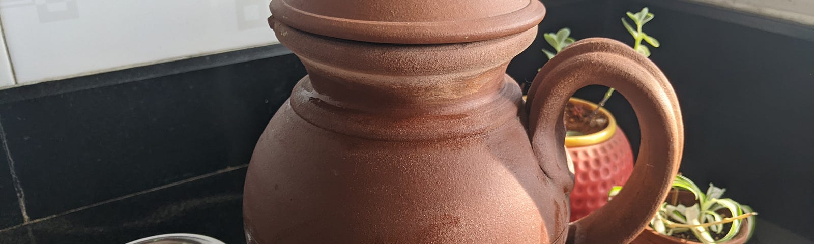 Earthern pot to keep water cool.
