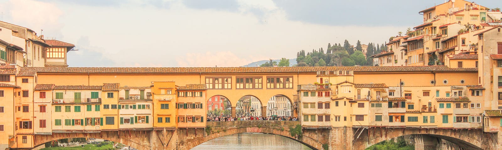 bridge in florence with colourful buildings banked on river