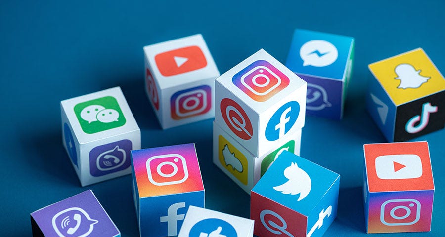 Social media app icons on colourful cubes against a blue background.