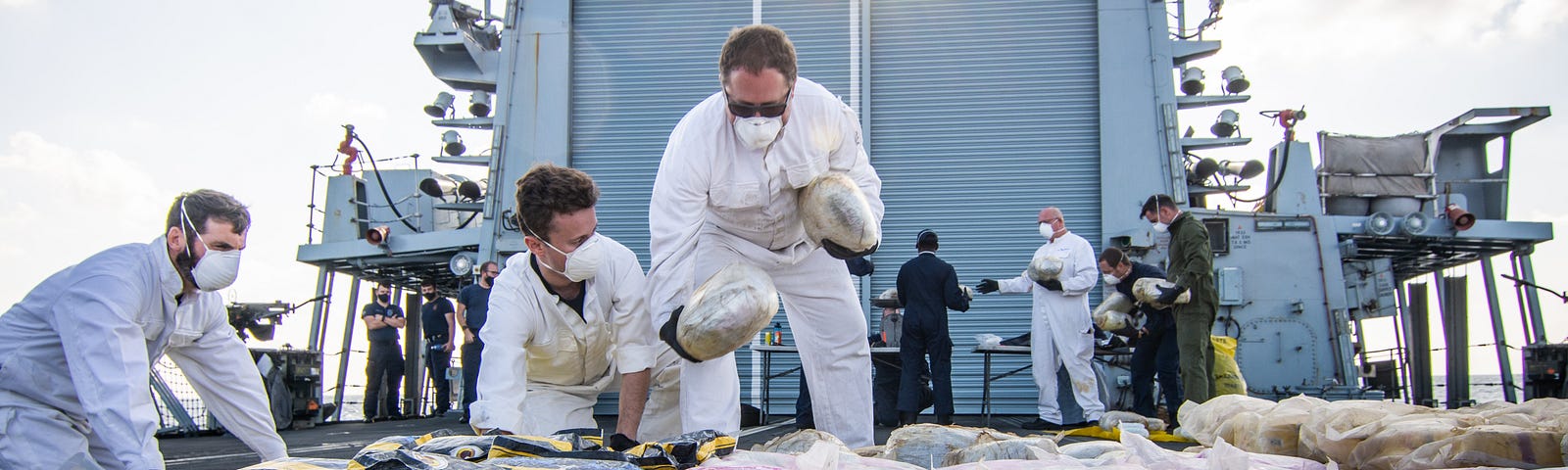 Crew on board the HMS Montrose categorising and weighing drugs seized in a drug bust off the coast of Oman