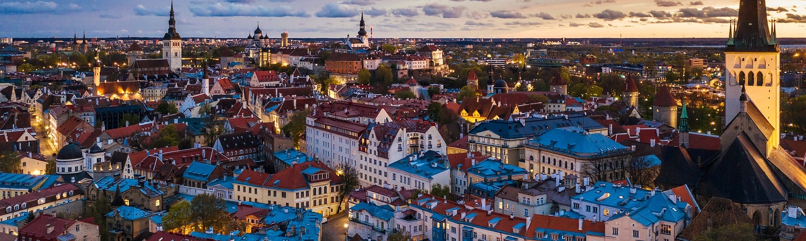 Tallinn vista do alto, com seus prédios, casas e natureza.
