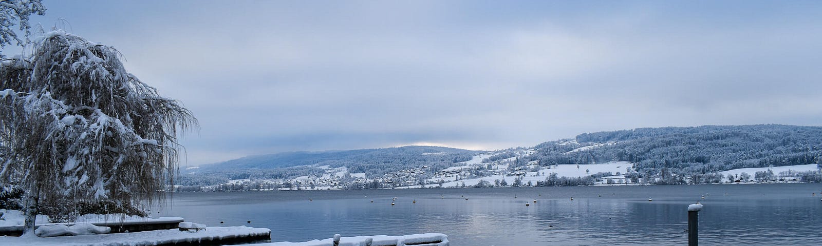 The Lake Greifensee in Zurich — rowboats covered in snow