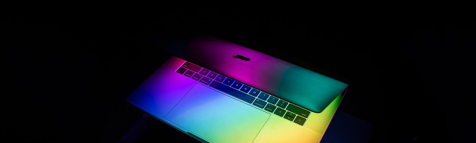 A laptop with rainbow colors highlighting it.