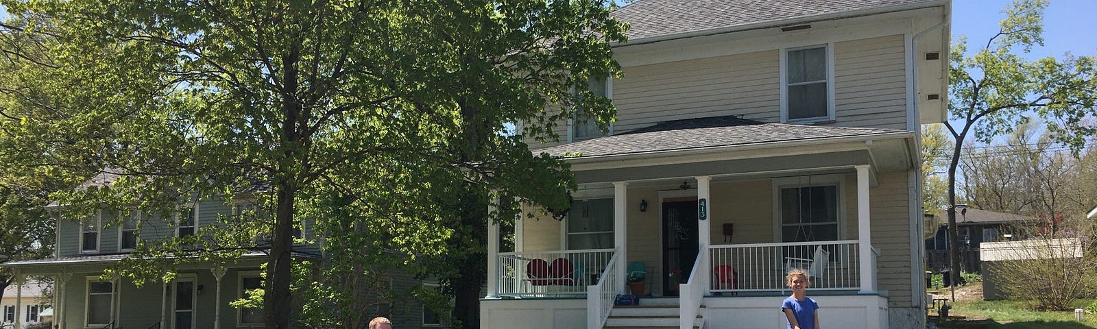 Father and daughter outside of a house.