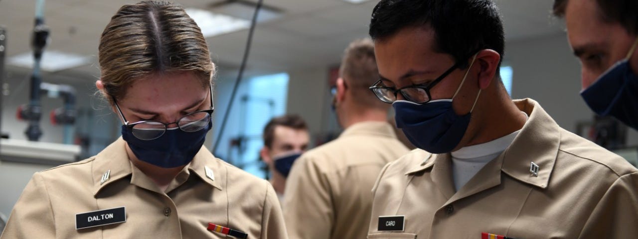 Students at Naval Nuclear Power Training Command (NNPTC), solve equations in a fluid theory lab.