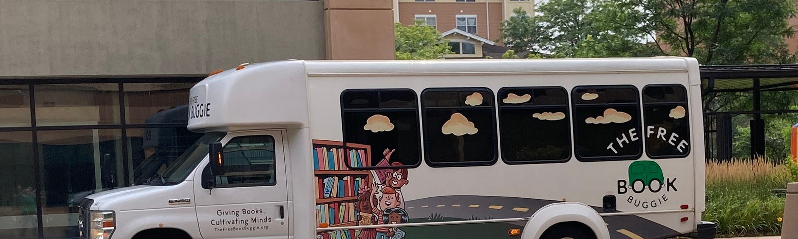 The Book Buggie mini-bus parked to offer free books for families