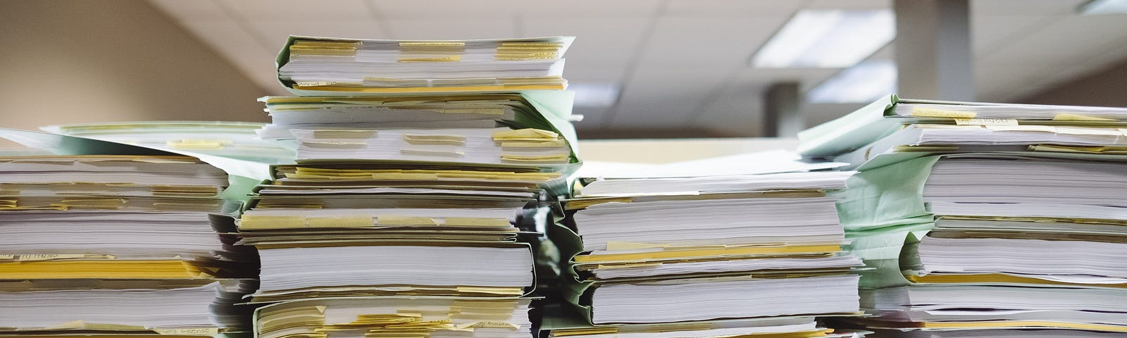 Several tall stacks of paper in folders