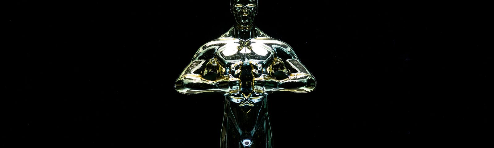 a black background and a perfect shot of the shiny, golden 96th Oscar statue in the middle also known as the Academy award