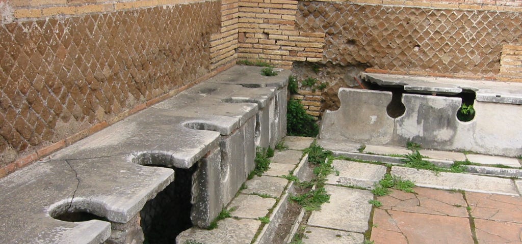 Ancient Romans in the bathroom — Public latrine in Ostia Antica, Italy