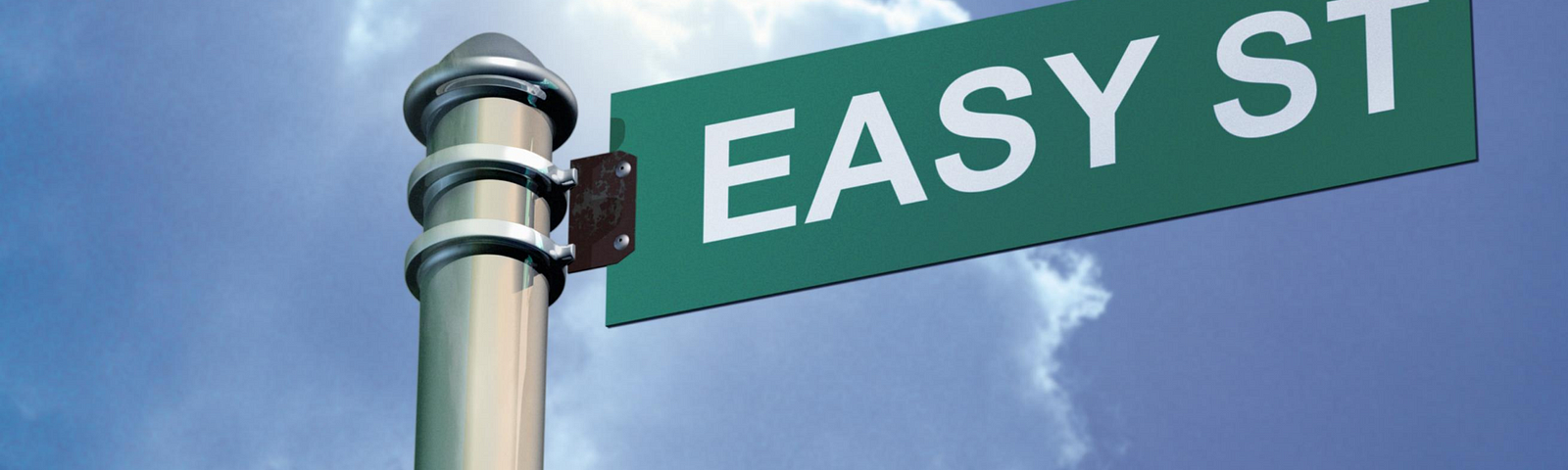 A pole with a green street sign. White text on the sign says, “easy street”