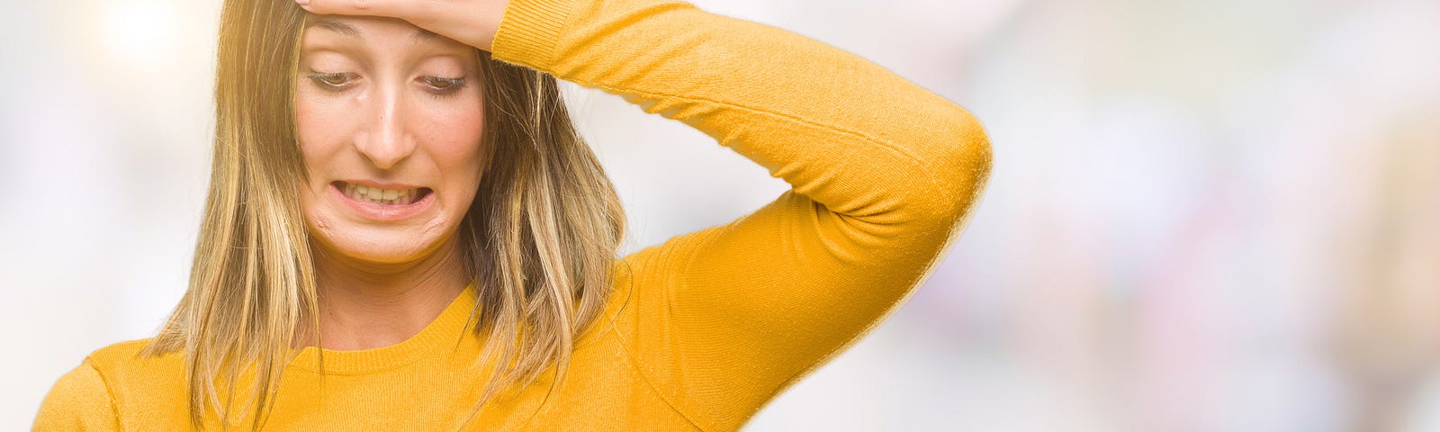 Woman looking disappointed while using her cell phone