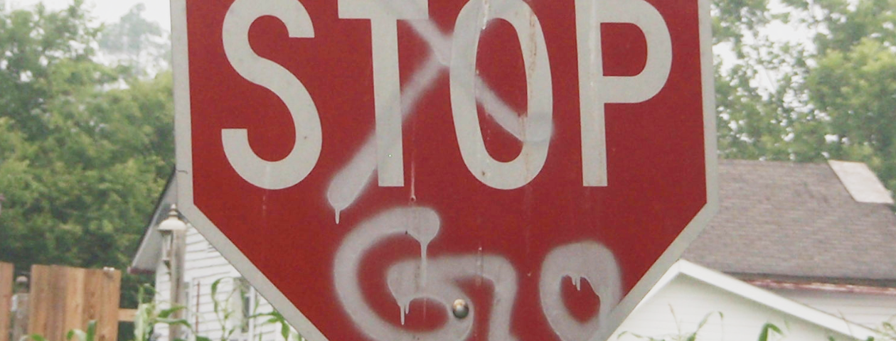 A Stop sign with the word “Stop” crudely crossed out and replaced with spray painted “Go”