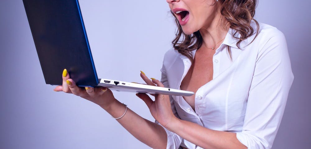Surprised Woman Holding a Laptop