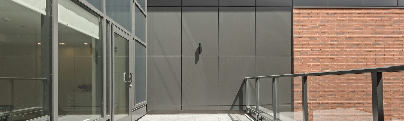 Concrete balcony with stainless steel and glass railing