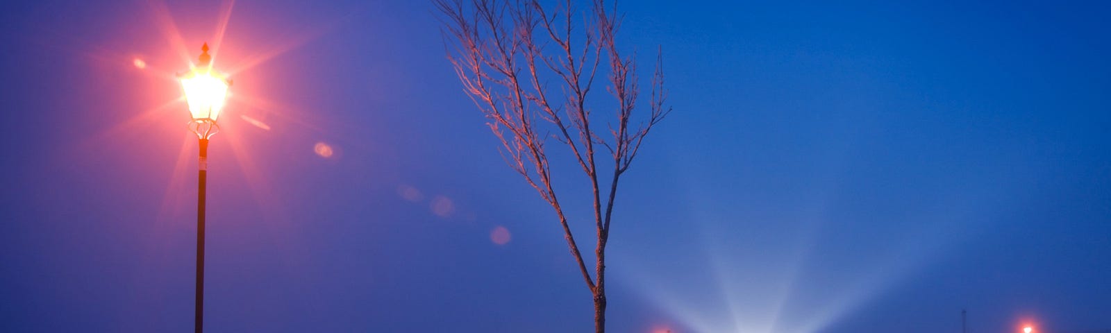 Winter night view of the Corrib river covered by cold fog and light rays in Claddagh