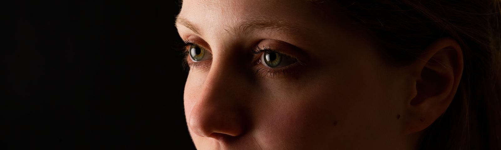 woman looking without smile on black background