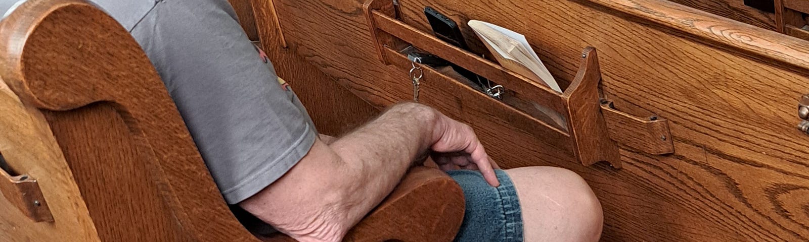 Gray haired man with service dog in church