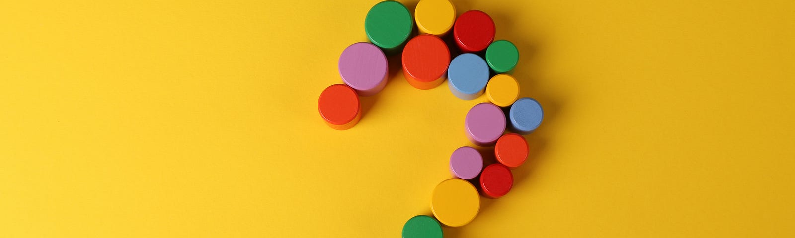 Yellow, Red, Green, and Blue Round Beads in the shape of a question mark.