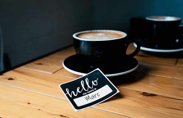 Coffee Cup and Name Tag on Table