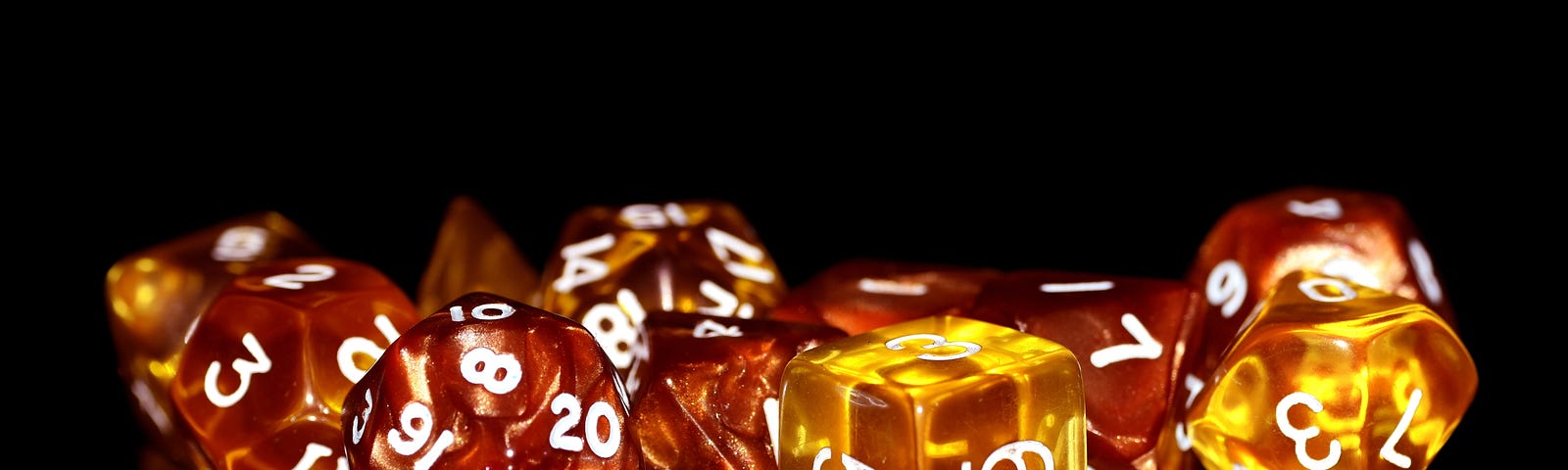 amber-colored dice on a black background
