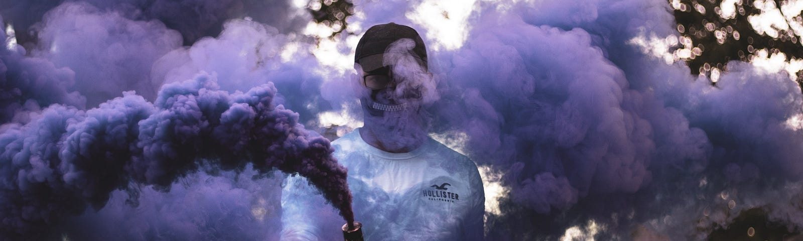 A person shrouded in purple smoke.