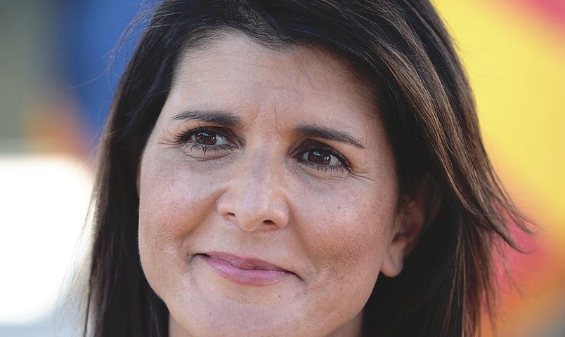 Headshot of Nikki Haley with multi-color background.
