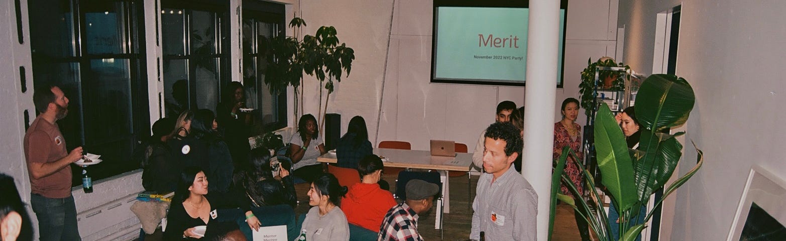 A candid photograph of groups of people talking in an event space.