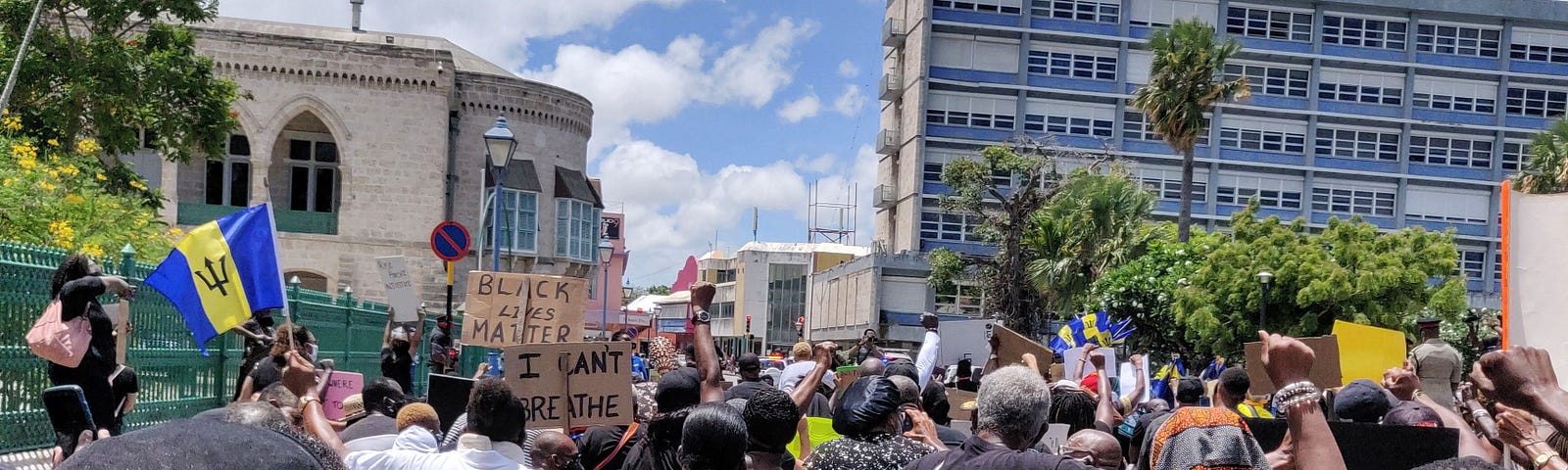 Black Lives Matter protest in Bridgetown, Barbados (photo by Sharon Hurley Hall) — shows people kneeling near to the Parliament building
