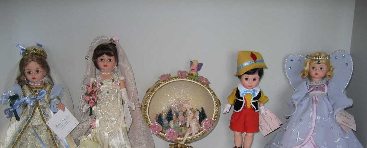 Four vintage dolls and a counter.