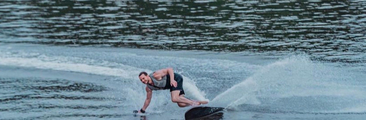 A surfer carving out in the open water