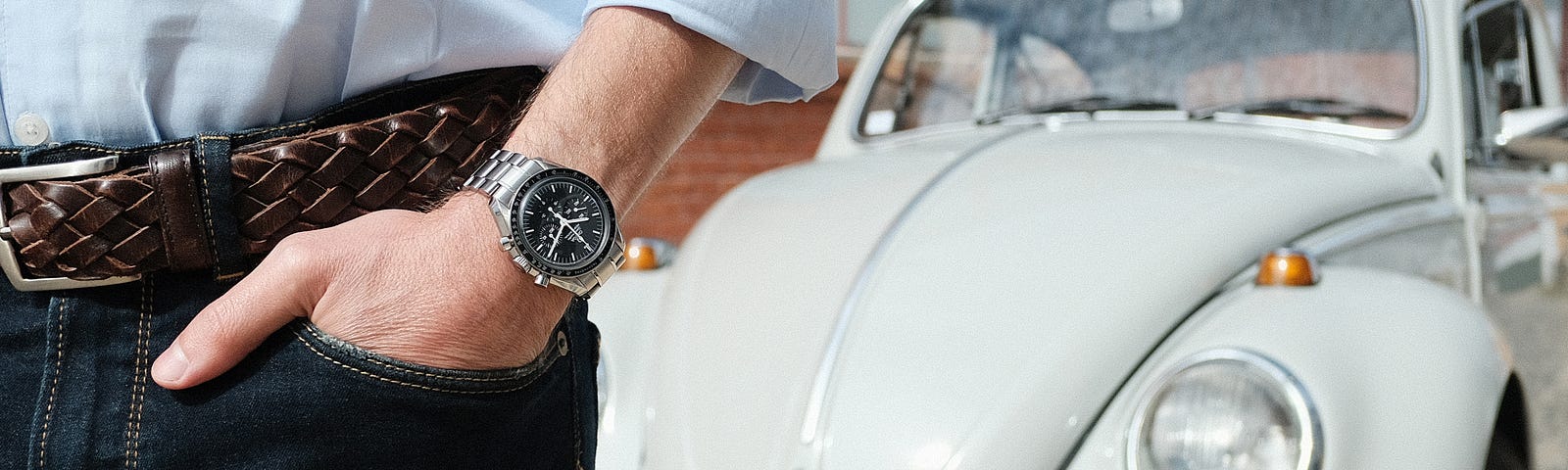 Pocket shot of the Omega Speedmaster with Bruno’s Volkswagen Beetle on the background