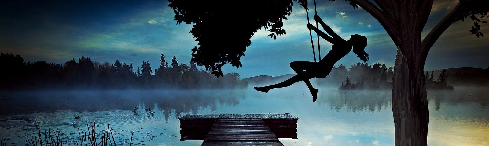 Woman in a swing, close to lake