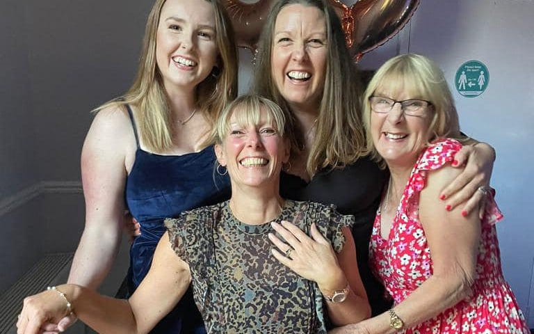 Photo of myself, with my mum, sister, and niece at my 50th party.
