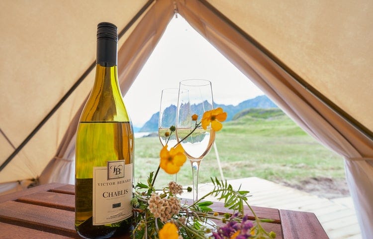 A bottle of Chablis in a tent overlooking the mountains