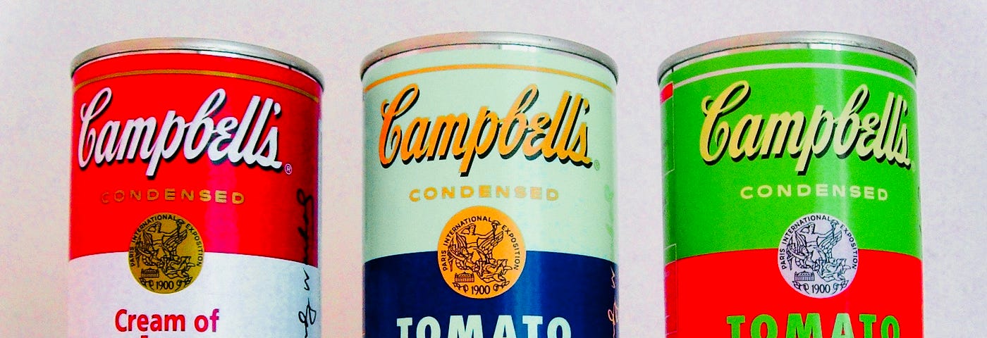 three vintage bright cans of Campbell’s soup from Andy Warhol