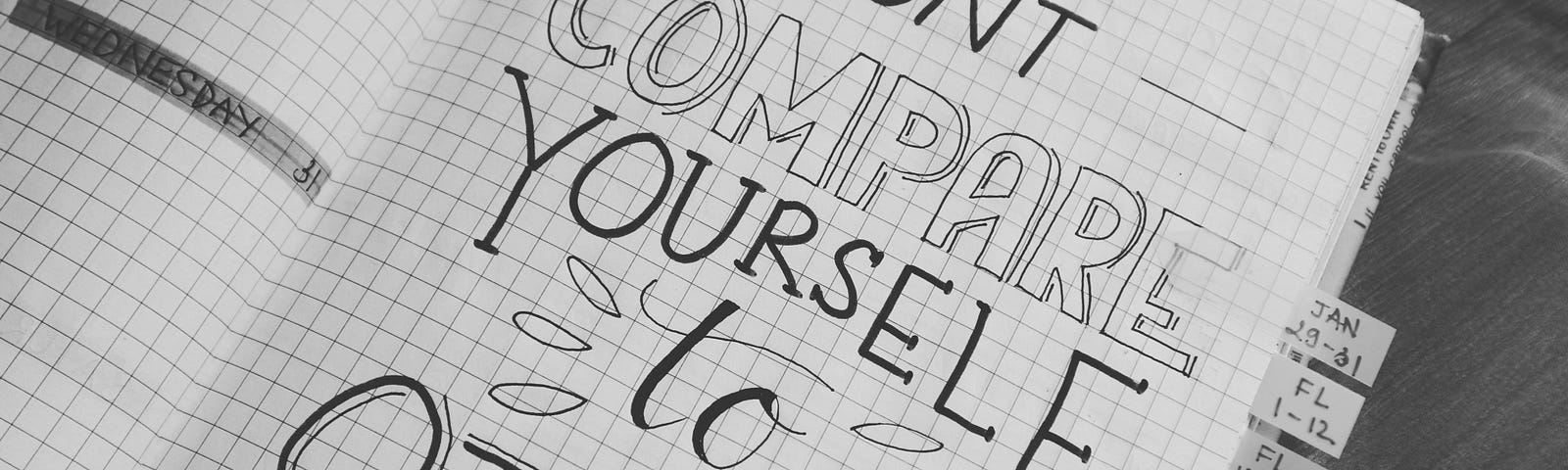 White grid notebook with words Don’t Compare Yourself to Others.