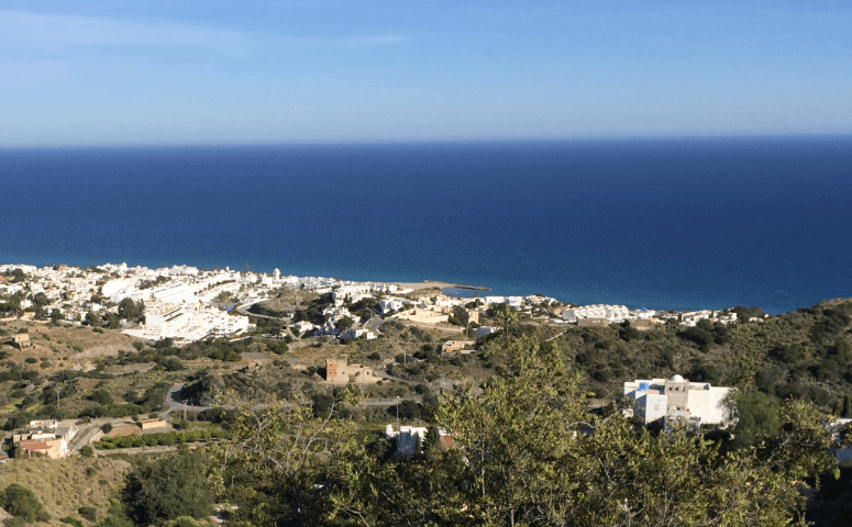 Mediterranean coastline with green bushes, white buildings, and an azure sea — Moral Letters to Lucilius