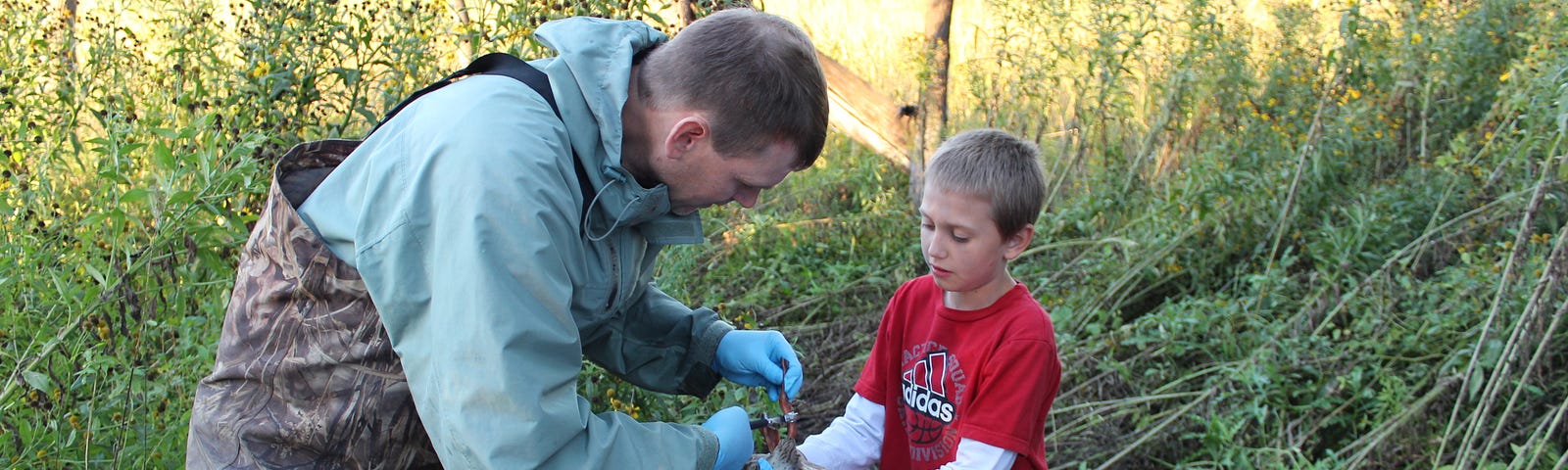 Tom Cooper, FWS Scholar, at work banding birds and educating kids about his work with the Service.