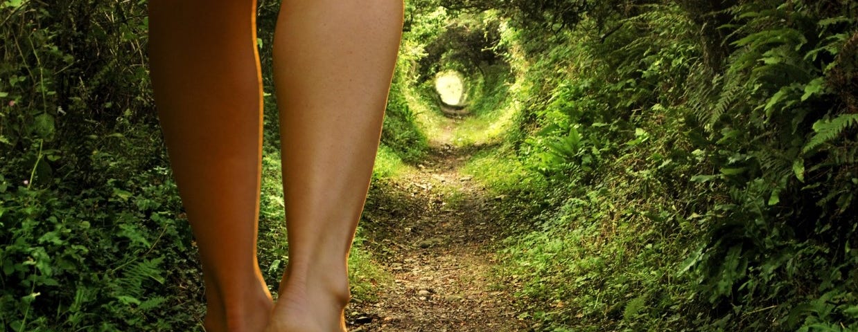 Female legs are walking through a tunnel with an unknown destination.