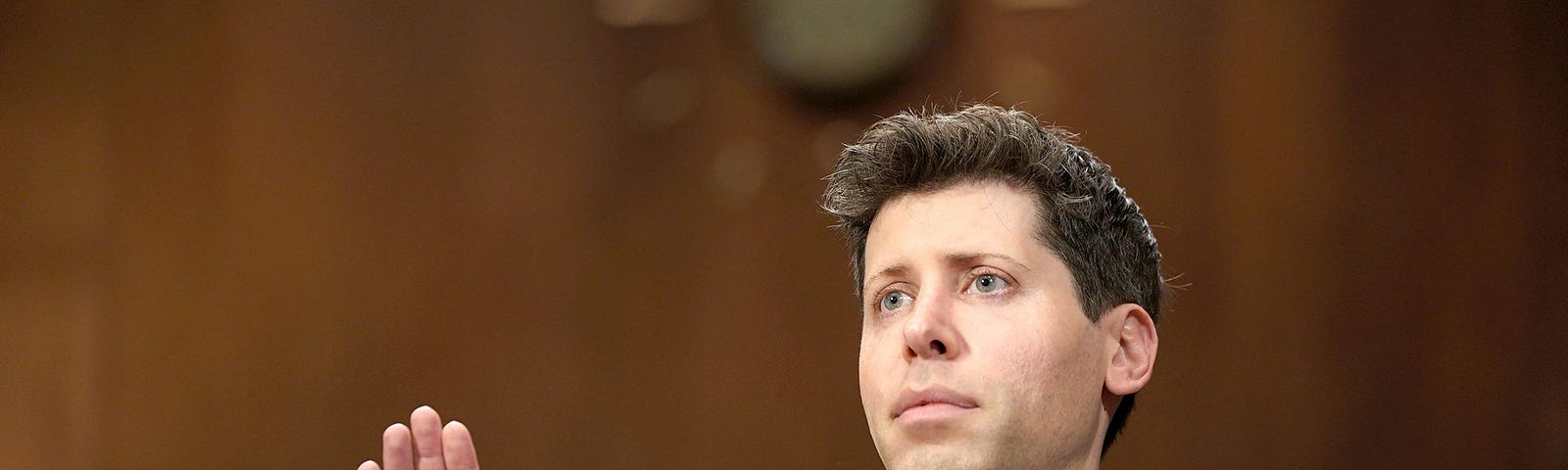 Sam altman pictured taking the oath during a congressional hearing
