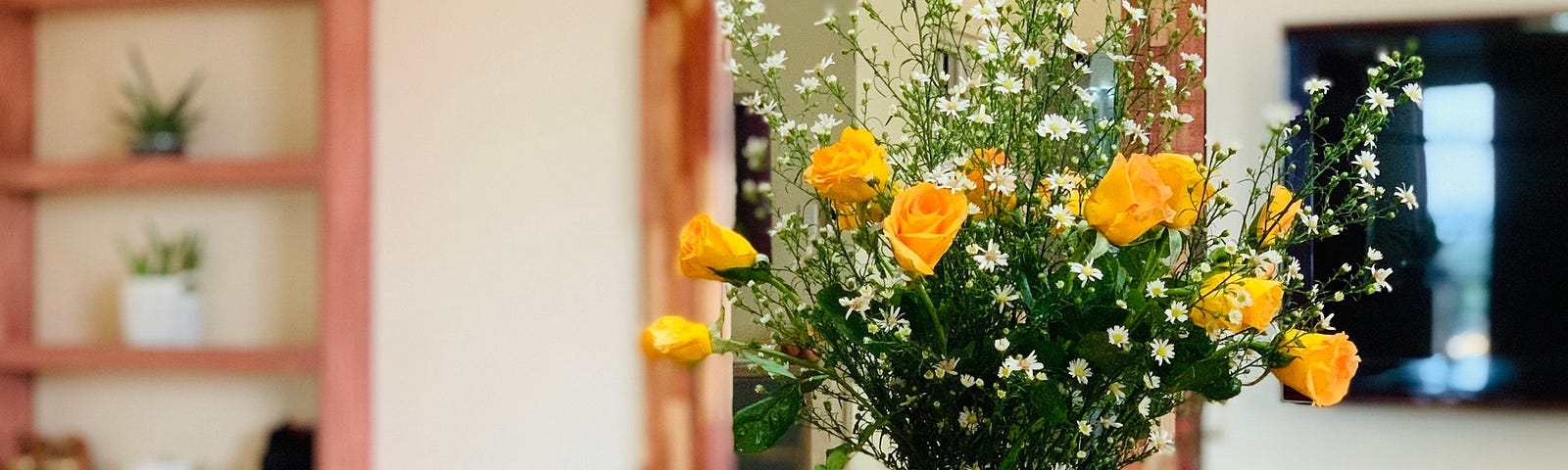 yellow flower on the wooden table