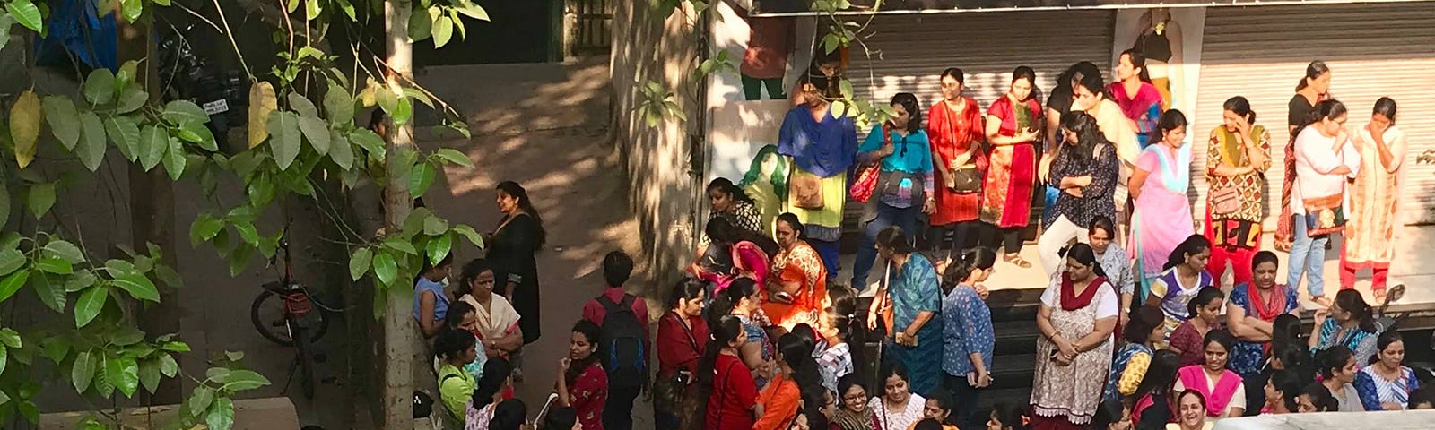 Parents standing outside a school.