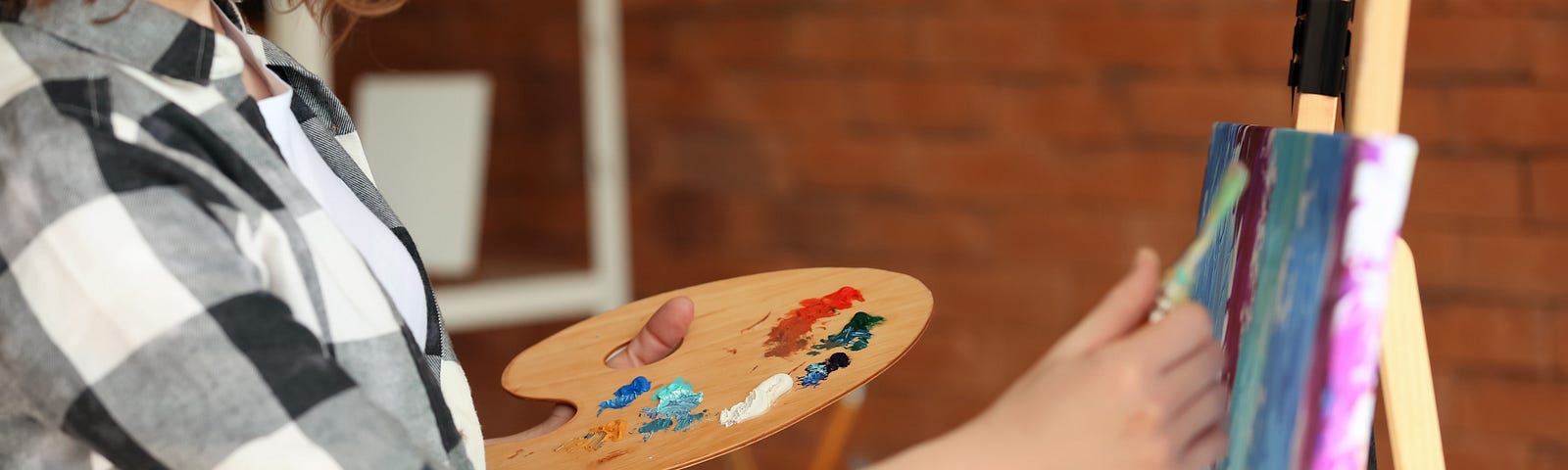 Female artist working at her easel.