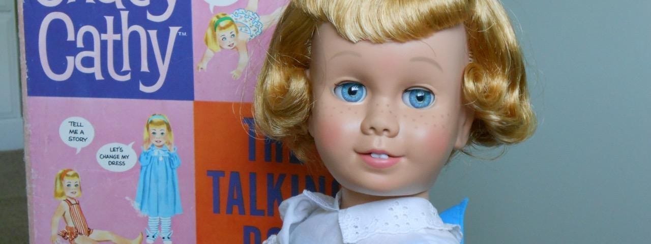 The original Chatty Cathy doll (1960): a white girl with blonde hair, blue eyes, and freckles.