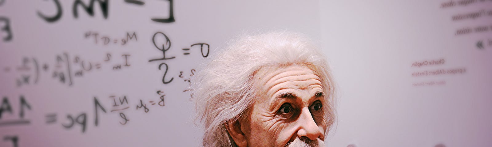 Albert Einstein in front of a white board.